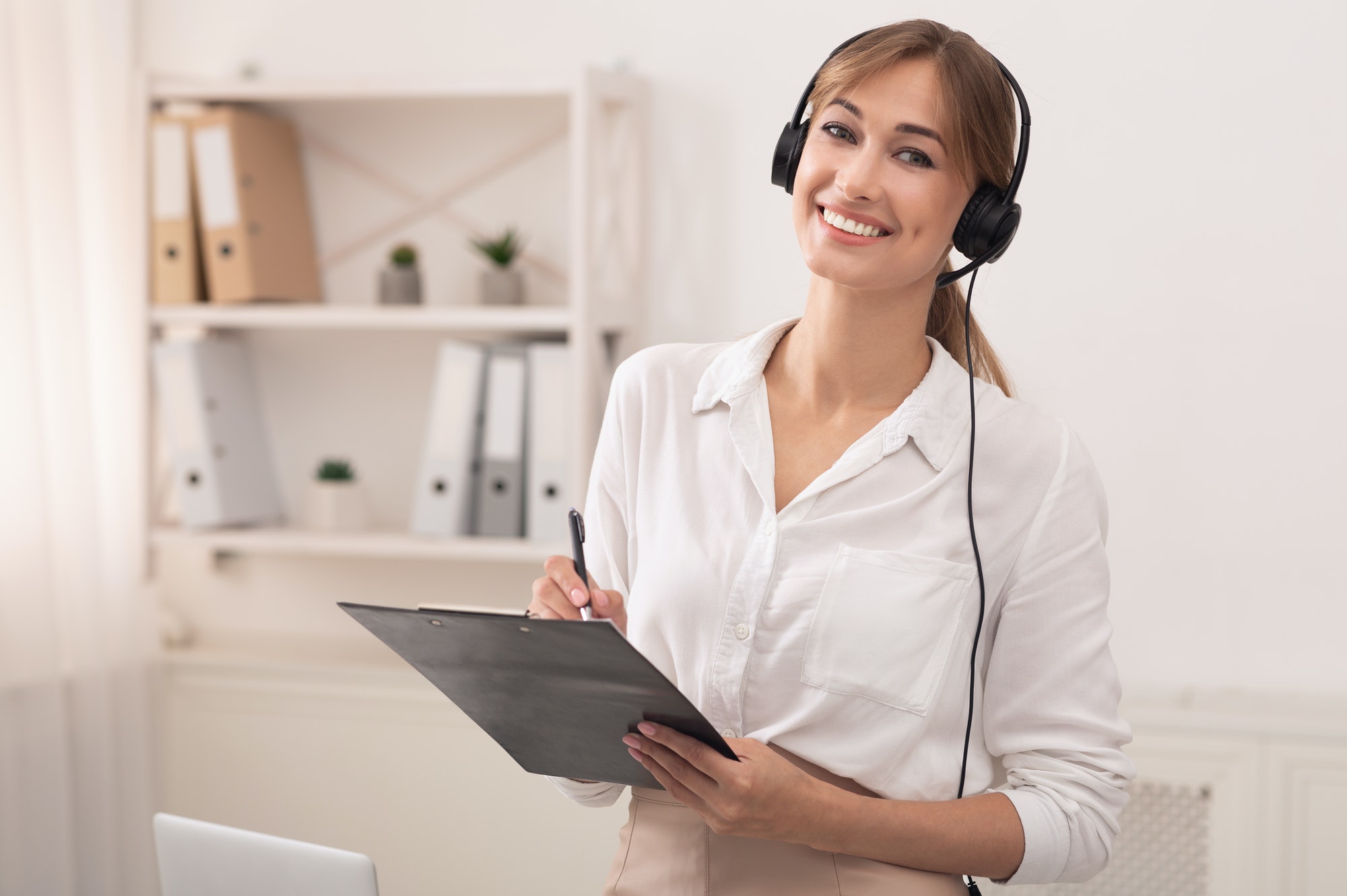 Woman In Headset Smiling Standing In Customer Support Office